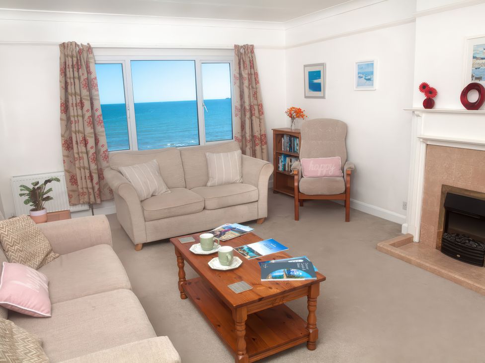 A living room with a view of the ocean at Weymouth Bay Apartment C in Greenhill