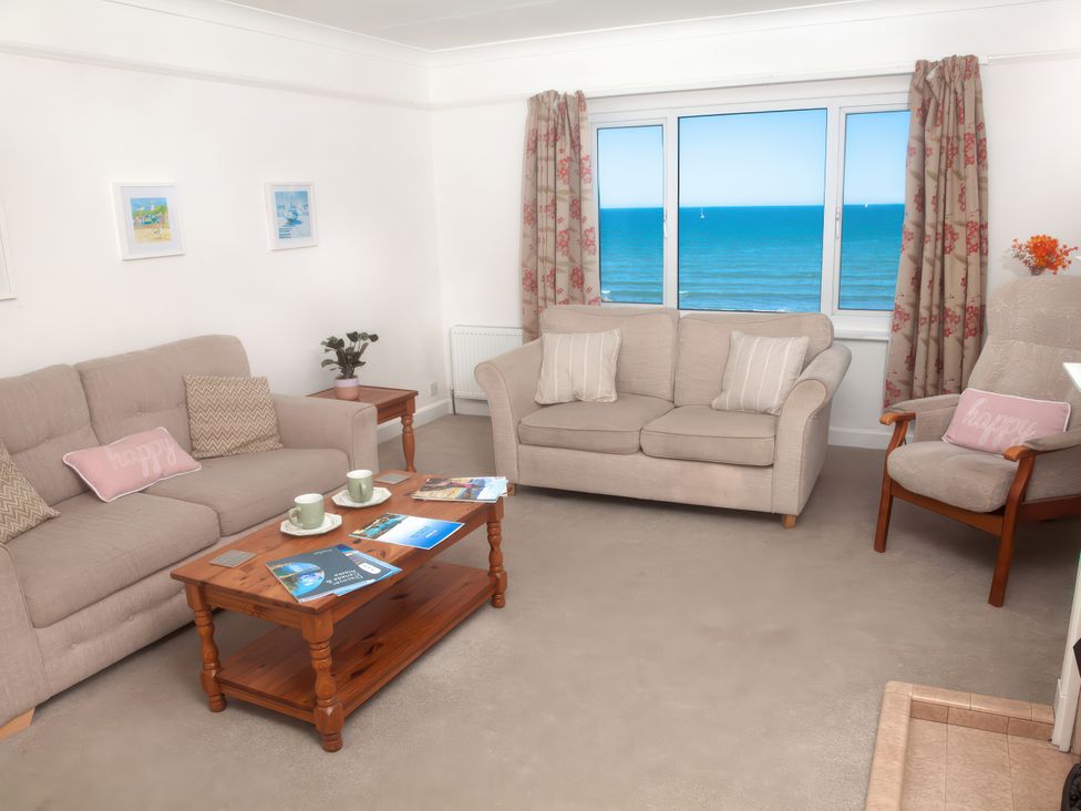 A living room with a view of the sea at Weymouth Bay Apartment C in Greenhill