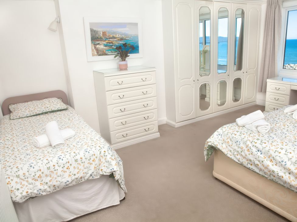A bedroom with two beds and furniture at Weymouth Bay Apartment C in Greenhill