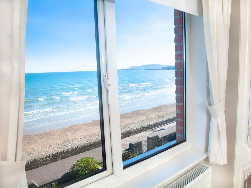 A view of the sea and beach from a window at Weymouth Bay Apartment C Greenhill