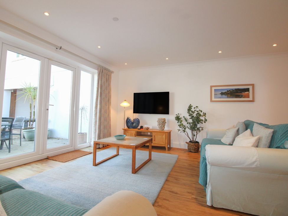 A living room with a coffee table and television at 16 Bolt Head Salcombe