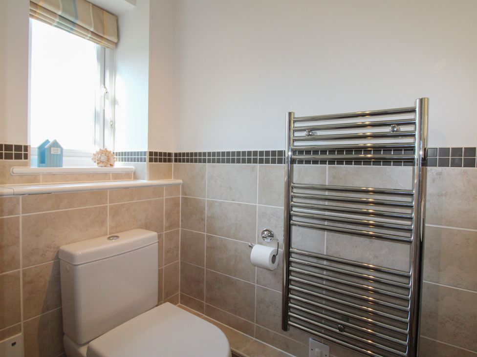 A bathroom featuring a toilet, towel rail, and window at 16 Bolt Head Salcombe