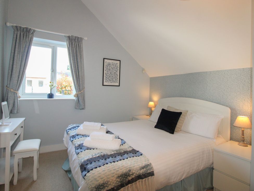 A bedroom with a bed and desk at 16 Bolt Head Salcombe