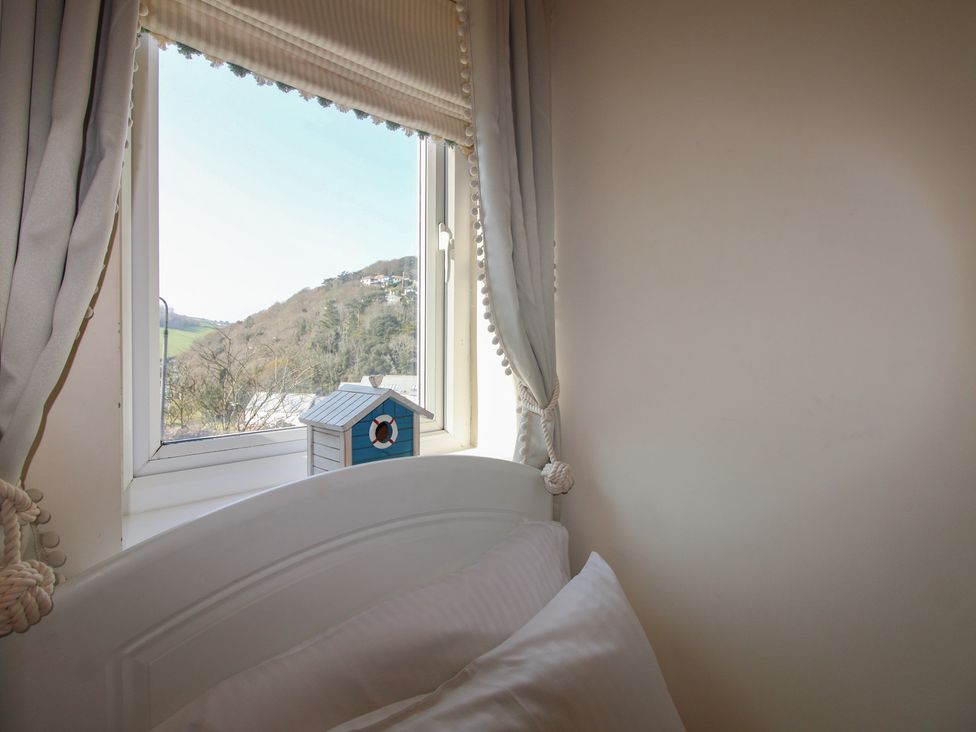A bedroom with a window and a bed at 16 Bolt Head in Salcombe
