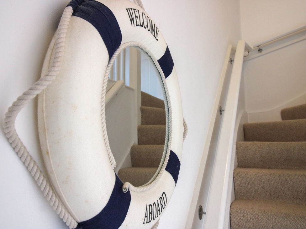A lifebuoy on the wall beside a staircase at 16 Bolt Head Salcombe
