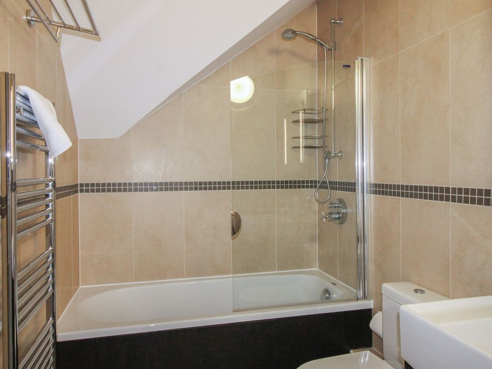 A bathroom with a shower and bathtub at 16 Bolt Head in Salcombe