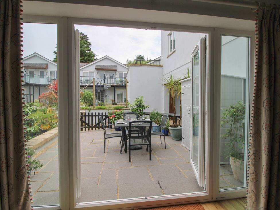 A patio area with chairs and table at 16 Bolt Head in Salcombe