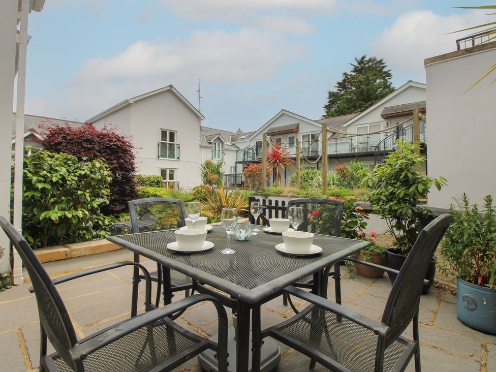 An outdoor dining area with a table and chairs at 16 Bolt Head Salcombe
