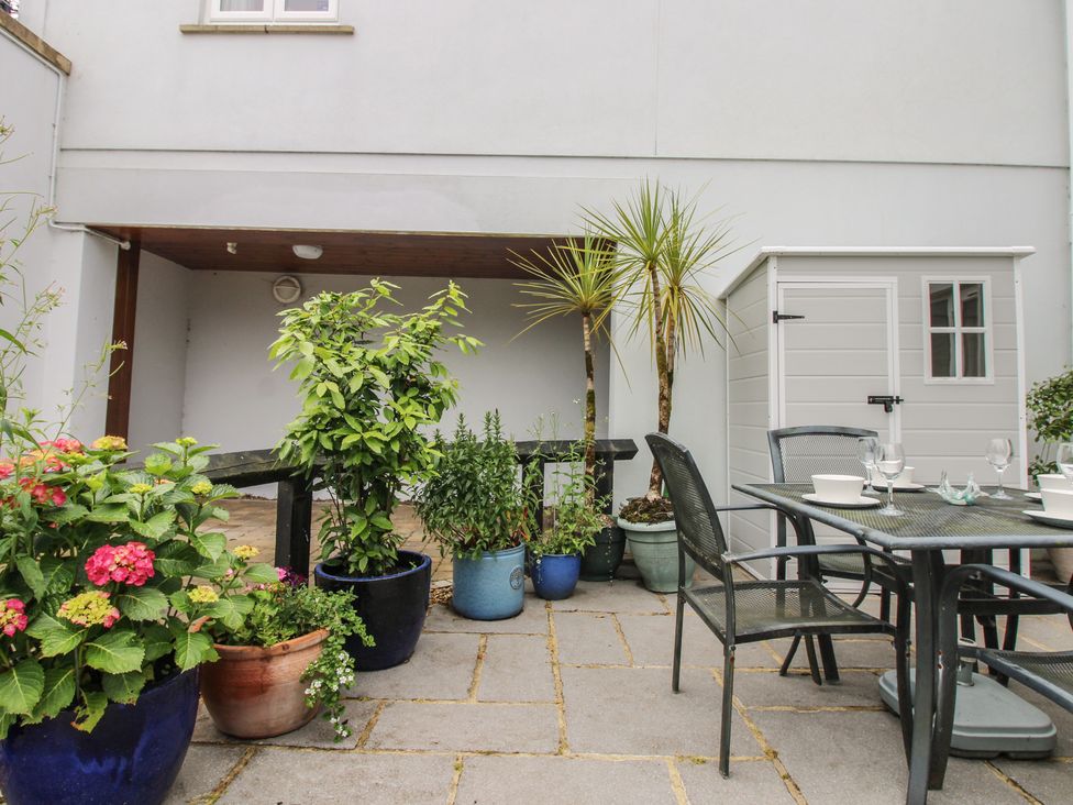 A garden area with plants and a table and chairs at 16 Bolt Head Salcombe