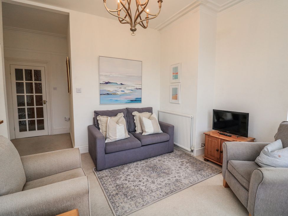 A living room with a couch and television at 1 Hazeldene in Salcombe