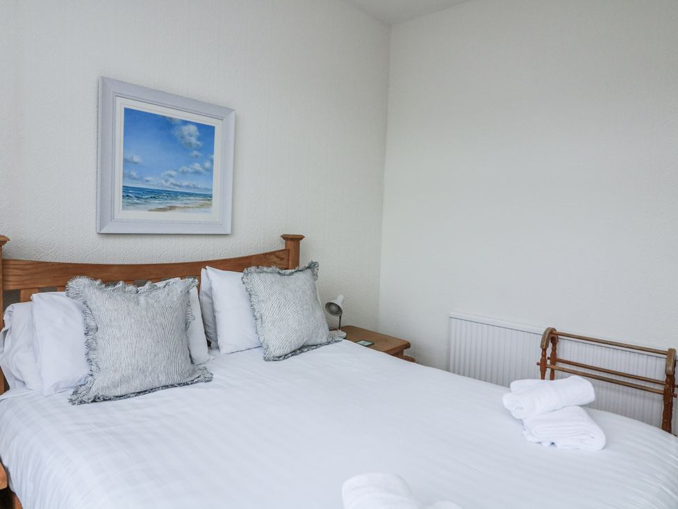 A bedroom with a bed and picture at 1 Hazeldene in Salcombe
