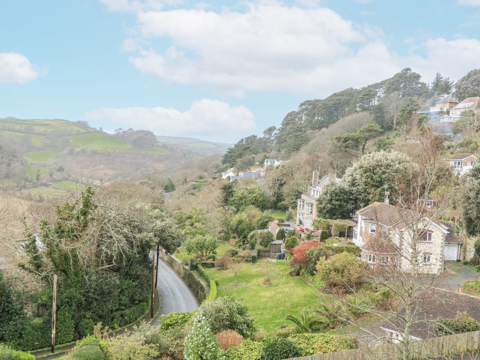 A view of houses and trees on a hillside at 1 Hazeldene in Salcombe