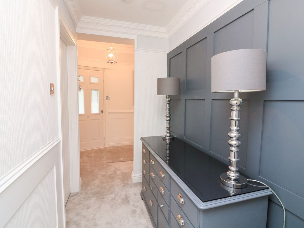A hallway with a dresser and lamps at 1 The Old Coach House Dartmouth