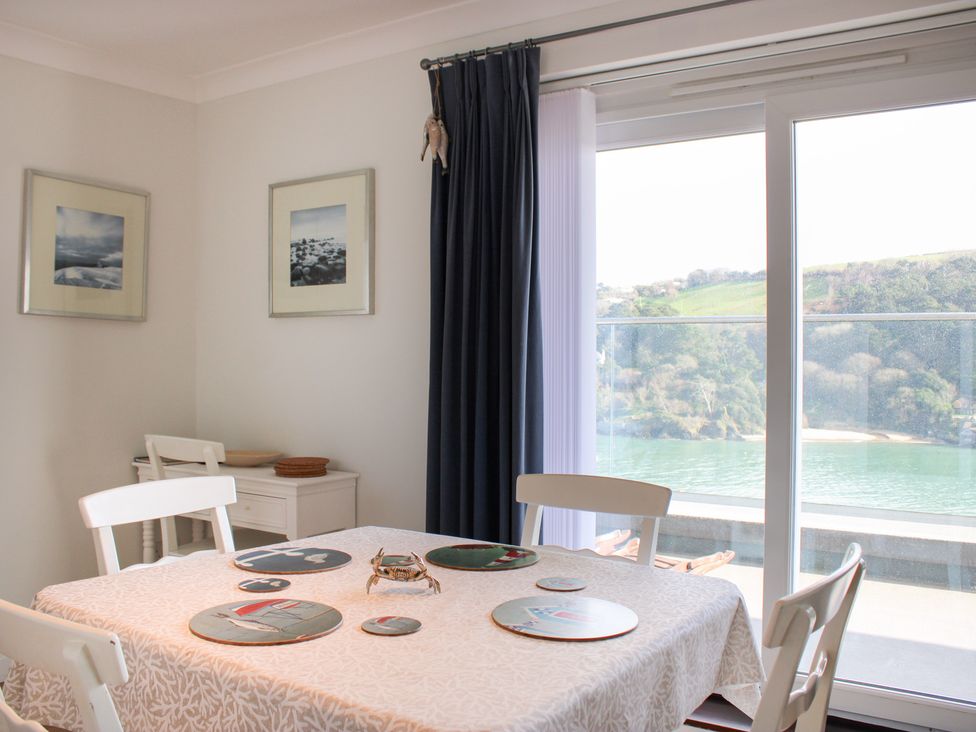 A dining room with a table and chairs at 2 Poundstone Court in Salcombe