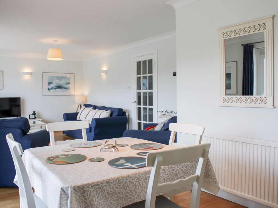 A living room with a dining table and sofa at 2 Poundstone Court in Salcombe