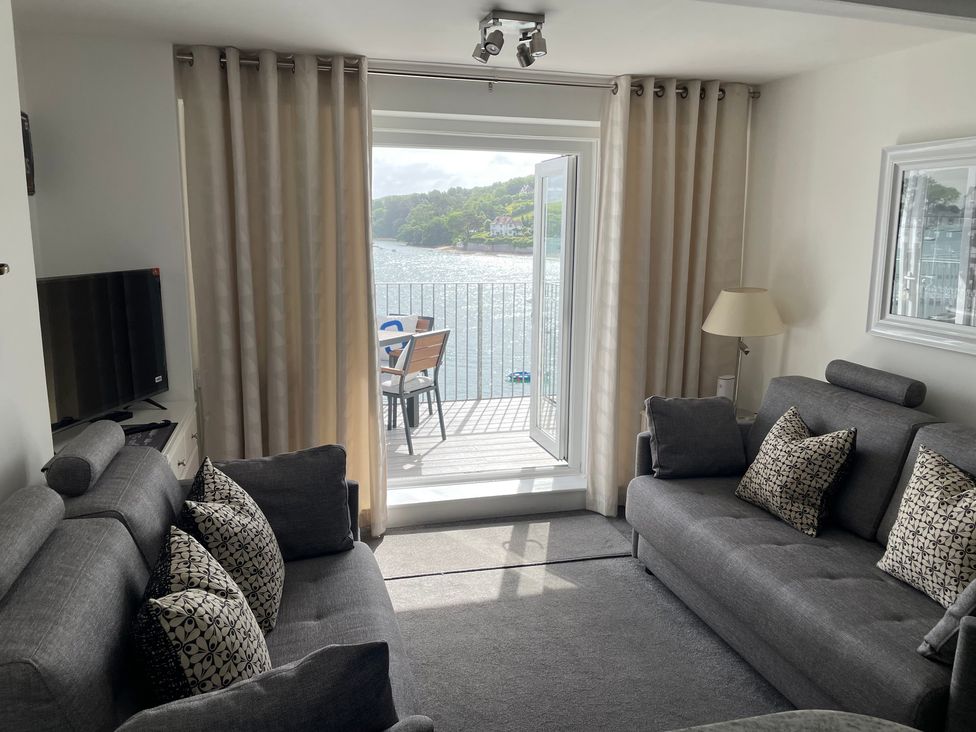 A living room with a view of water in 35 The Salcombe, Salcombe