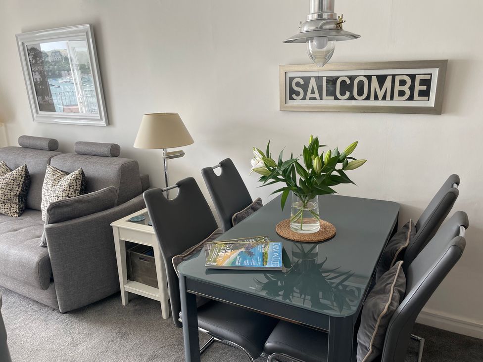 A dining area with a table and chairs at 35 The Salcombe, Salcombe
