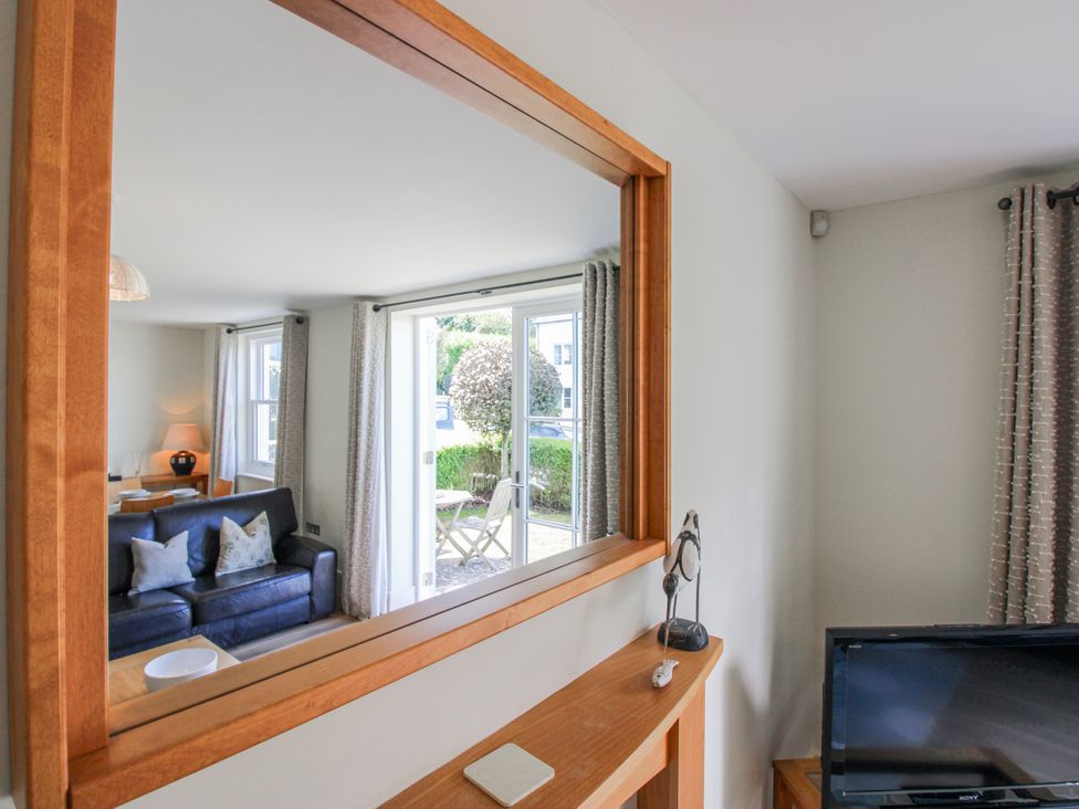 A living room with a sofa and television at 3 Combehaven Salcombe