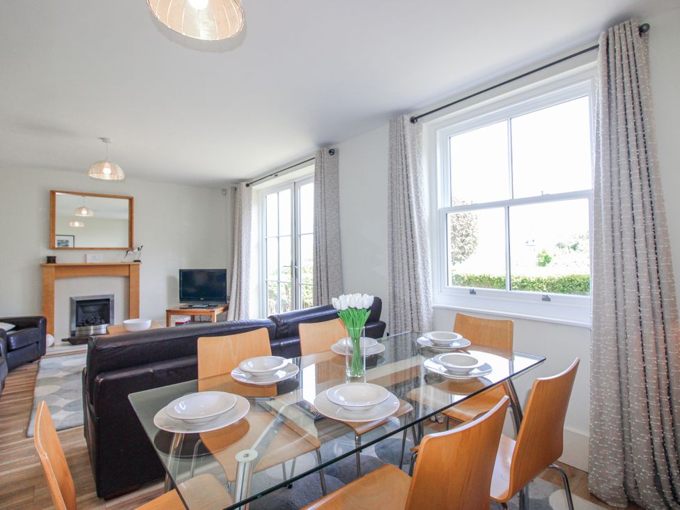 A dining room with a table and chairs at 3 Combehaven Salcombe