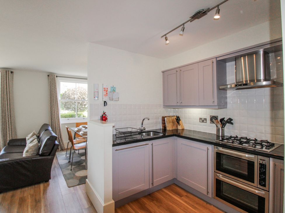 A kitchen featuring stove and sink at 3 Combehaven in Salcombe