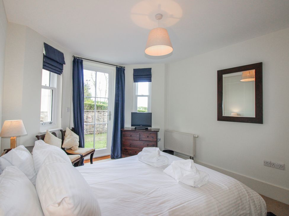 A bedroom with a bed and television at 3 Combehaven Salcombe
