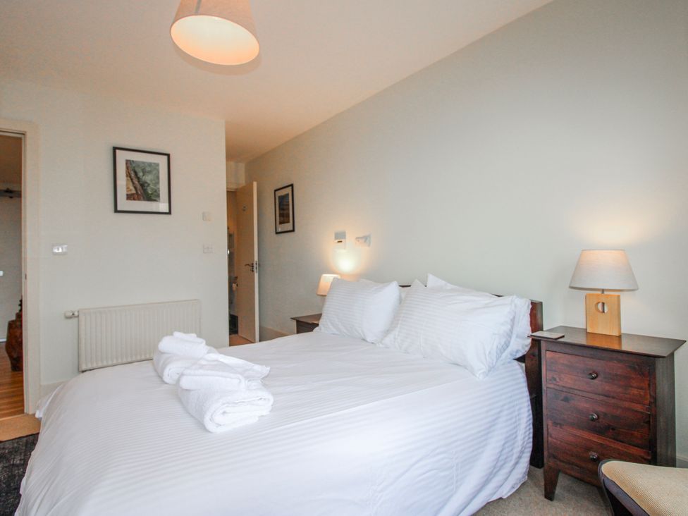 A bedroom with a bed and nightstand at 3 Combehaven Salcombe