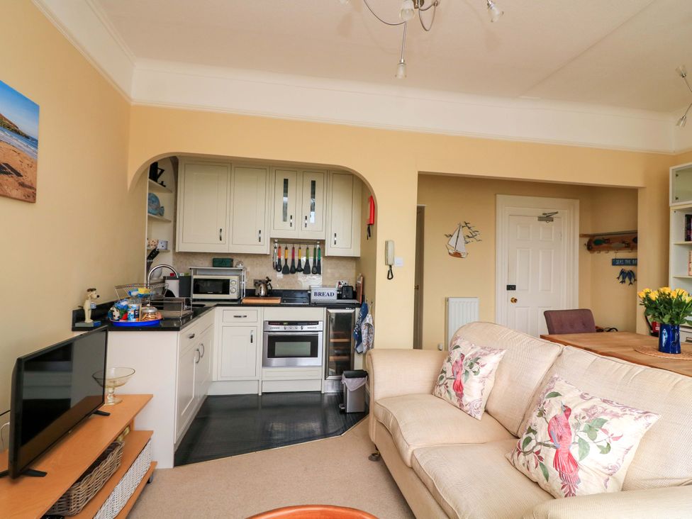 A living room with kitchen appliances and a sofa at 3 Dartview in Dartmouth
