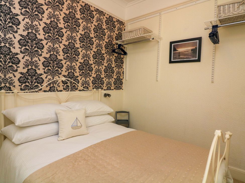 A bedroom with a bed and shelving at 3 Dartview in Dartmouth