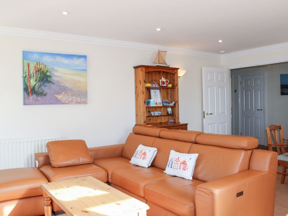 A living room with a sofa and coffee table at 3 Thurlestone Rock in Thurlestone