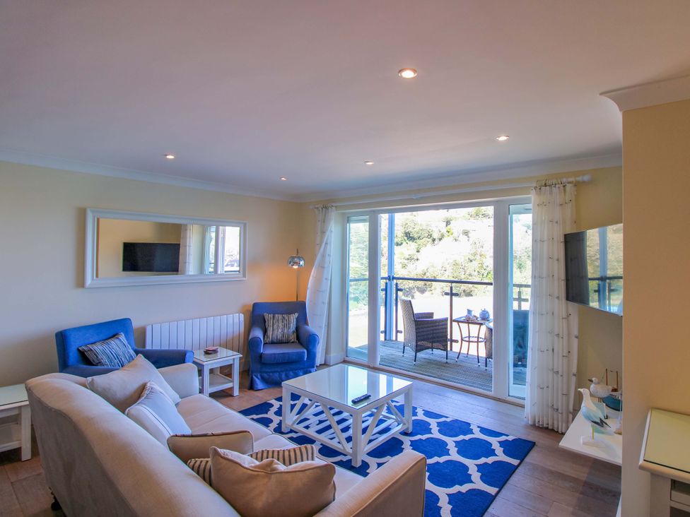 A living room with a sofa and armchair at 4 Bolt Head in Salcombe