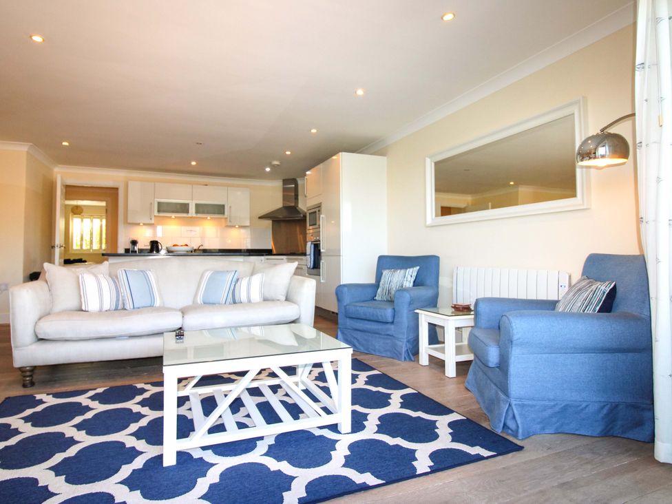 A living room with a sofa and armchairs at 4 Bolt Head in Salcombe