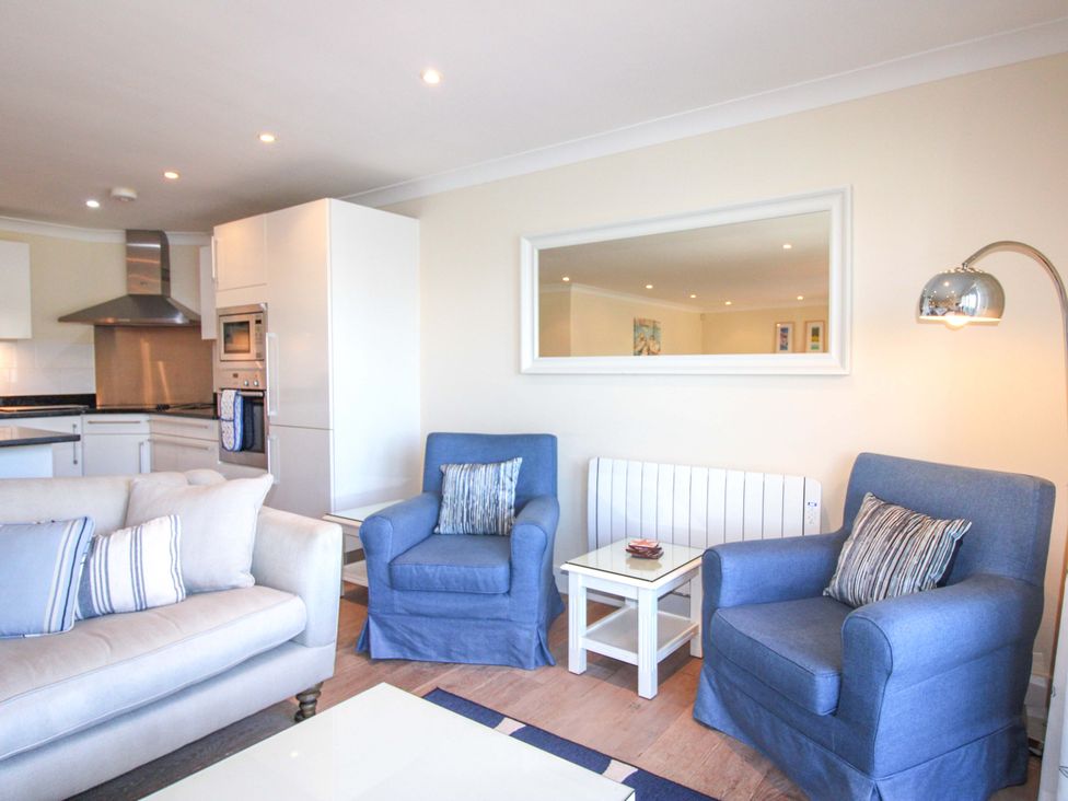 A living room with sofa and armchairs at 4 Bolt Head in Salcombe