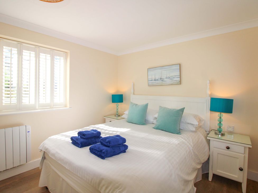 A bedroom with a bed and side table at 4 Bolt Head Salcombe