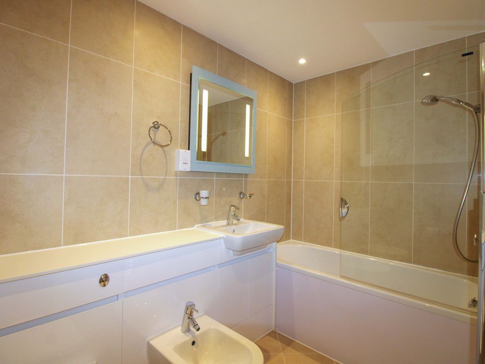 A bathroom with a bathtub and sink at 4 Bolt Head Salcombe