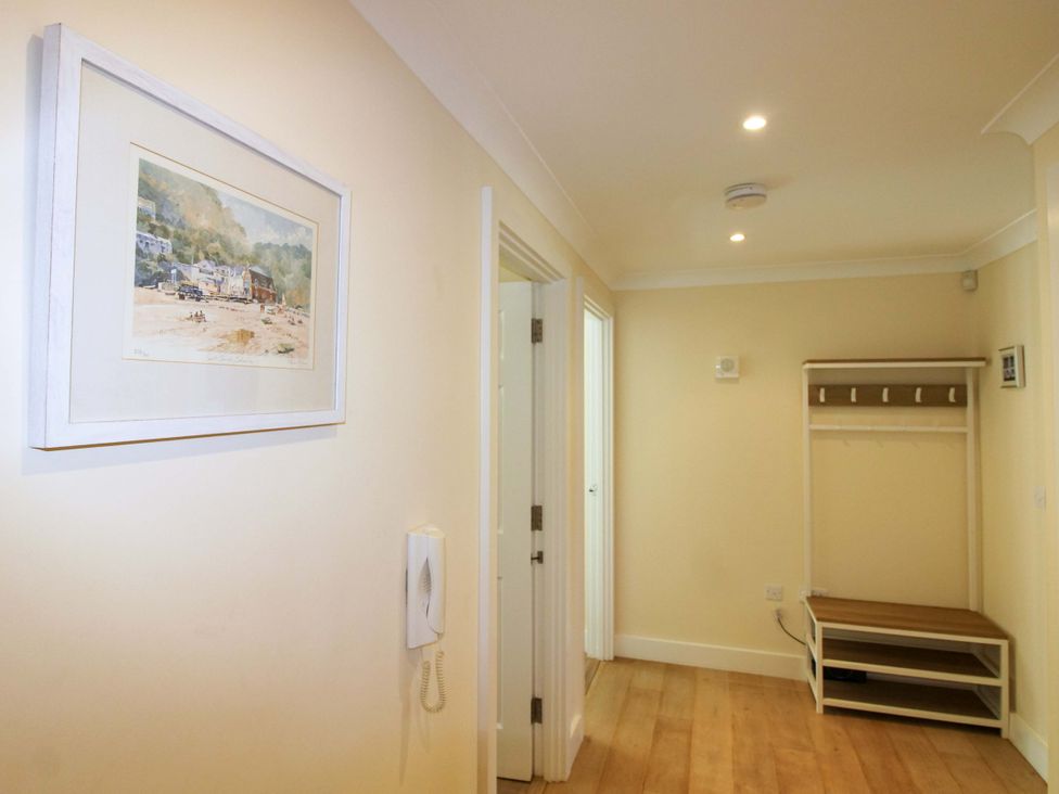 A hallway with a coat rack and a telephone at 4 Bolt Head in Salcombe
