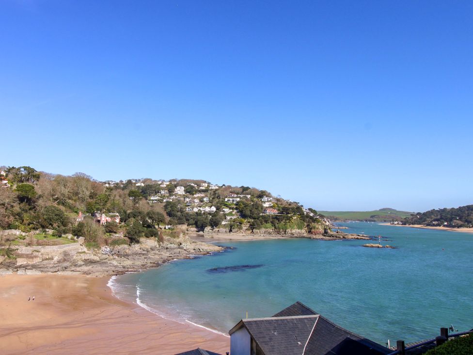 A beach with water and houses at 4 Bolt Head in Salcombe