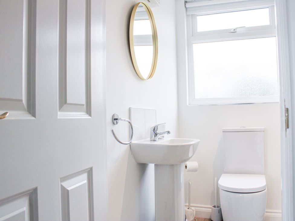 A bathroom with a sink and toilet at 4 Lyndhurst in Salcombe