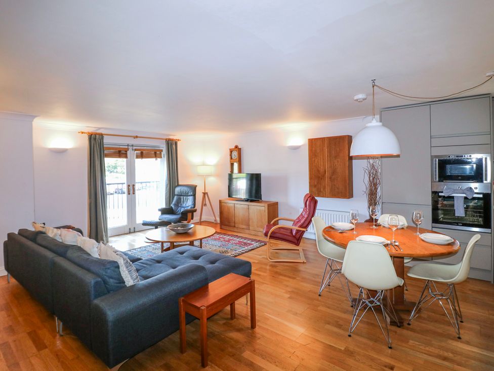 A living room with a sofa, dining area, and television at 5 Dartmouth House in Dartmouth