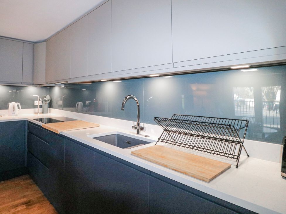 A kitchen with a sink and cutting board at 5 Dartmouth House Dartmouth