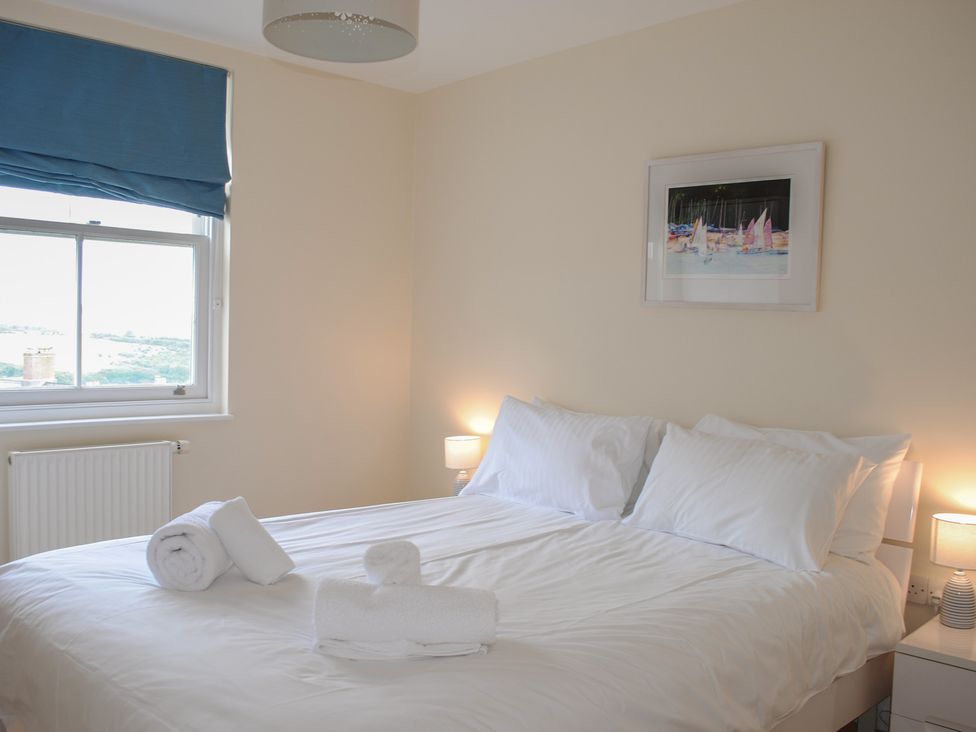 A bedroom with a bed and window at 6 Combehaven, Salcombe