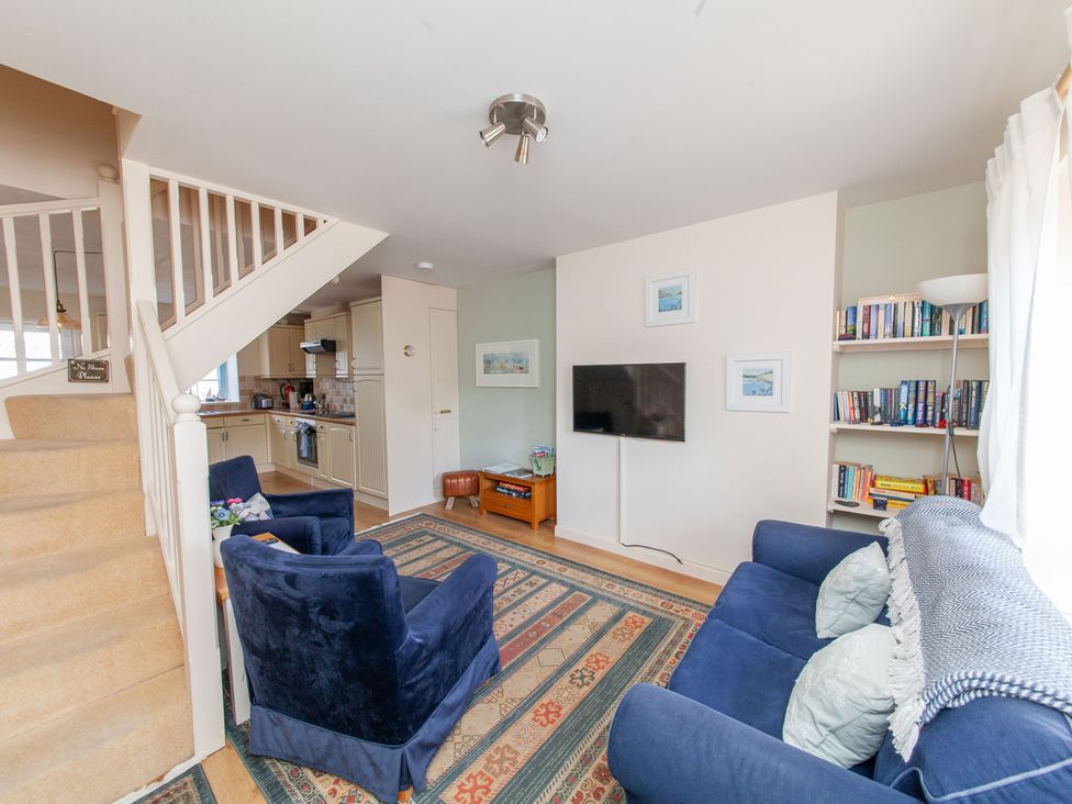 A living room with a television and bookshelves at 7 Charles Street Dartmouth