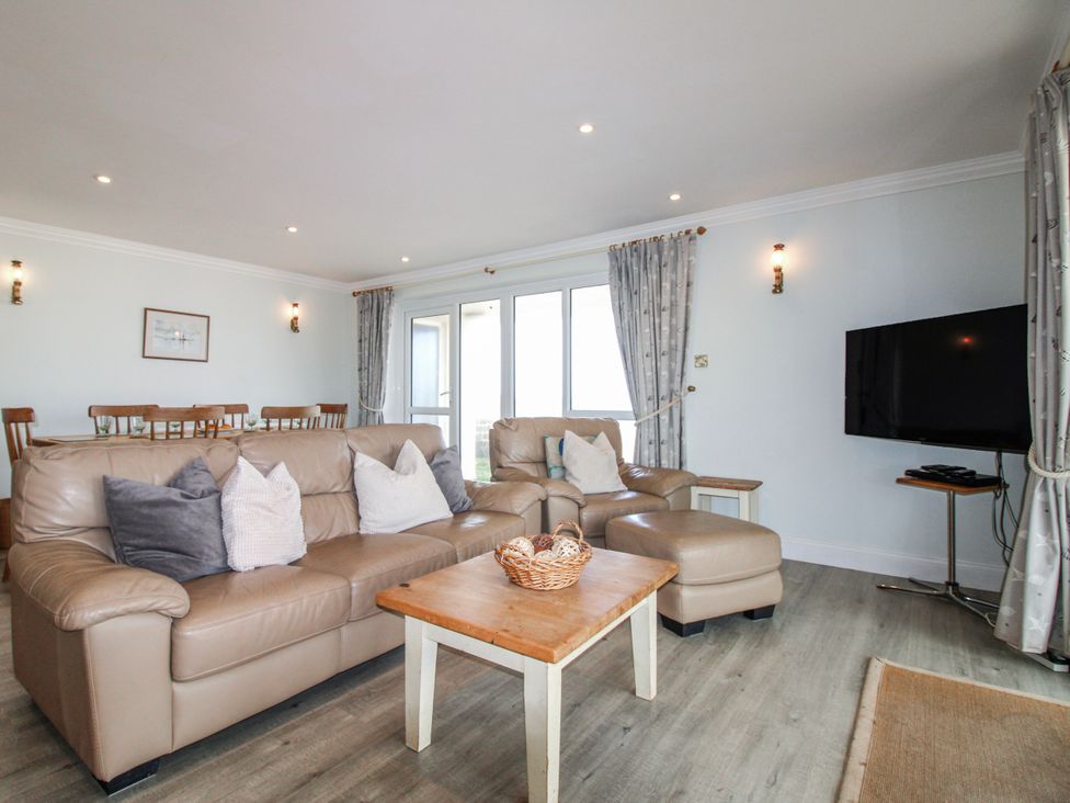 A living room with seating and a television at 7 Thurlestone Rock in Thurlestone