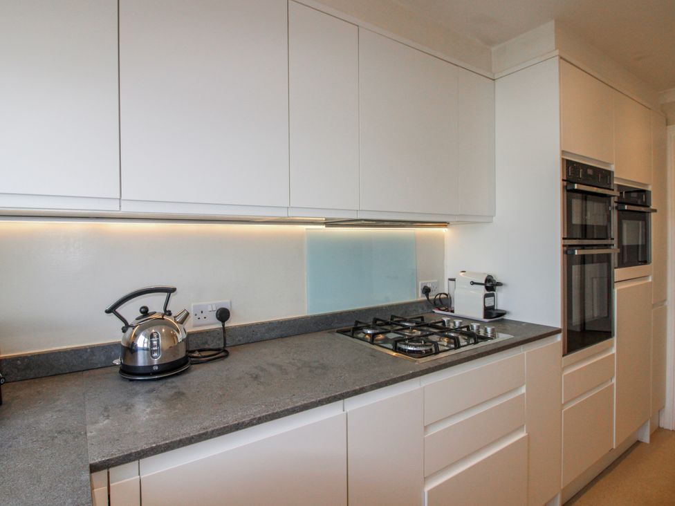 A kitchen with a kettle, hobs and ovens at 7 Thurlestone Rock in Thurlestone