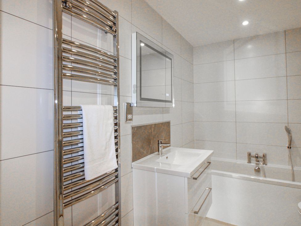 A bathroom with a sink and bathtub at 7 Thurlestone Rock in Thurlestone