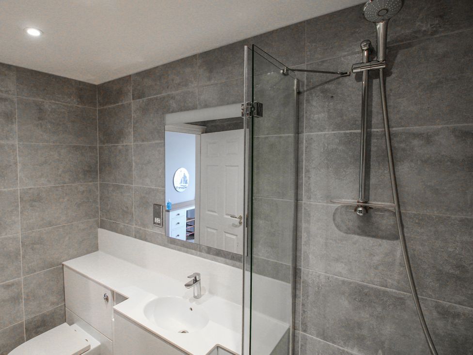 A bathroom with shower, sink, and toilet at 7 Thurlestone Rock in Thurlestone