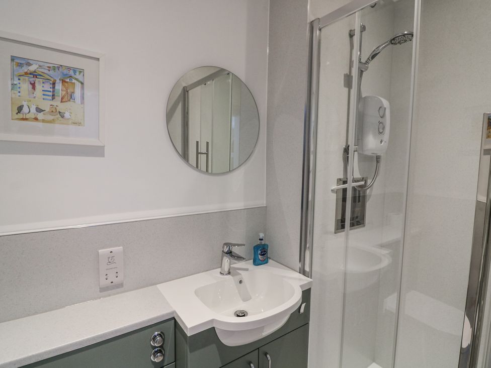 A bathroom with a sink and shower at Armada Cottage Dartmouth