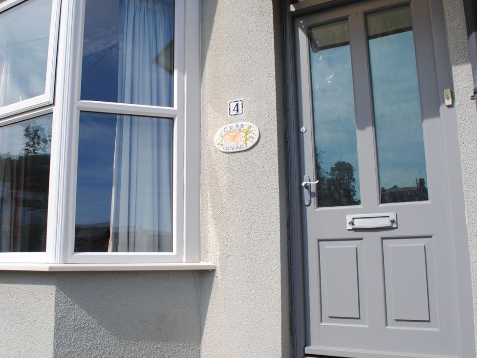 An entrance with a door and a window at Crab Cottage in Salcombe
