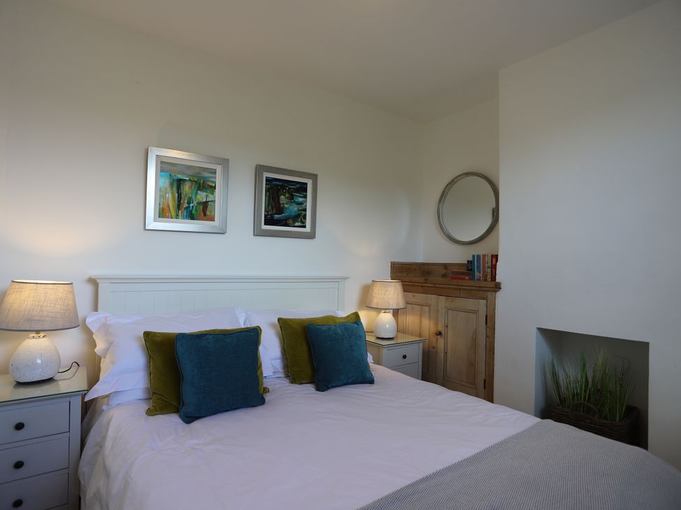 A bedroom with a bed and nightstand at Dart Views in Dartmouth