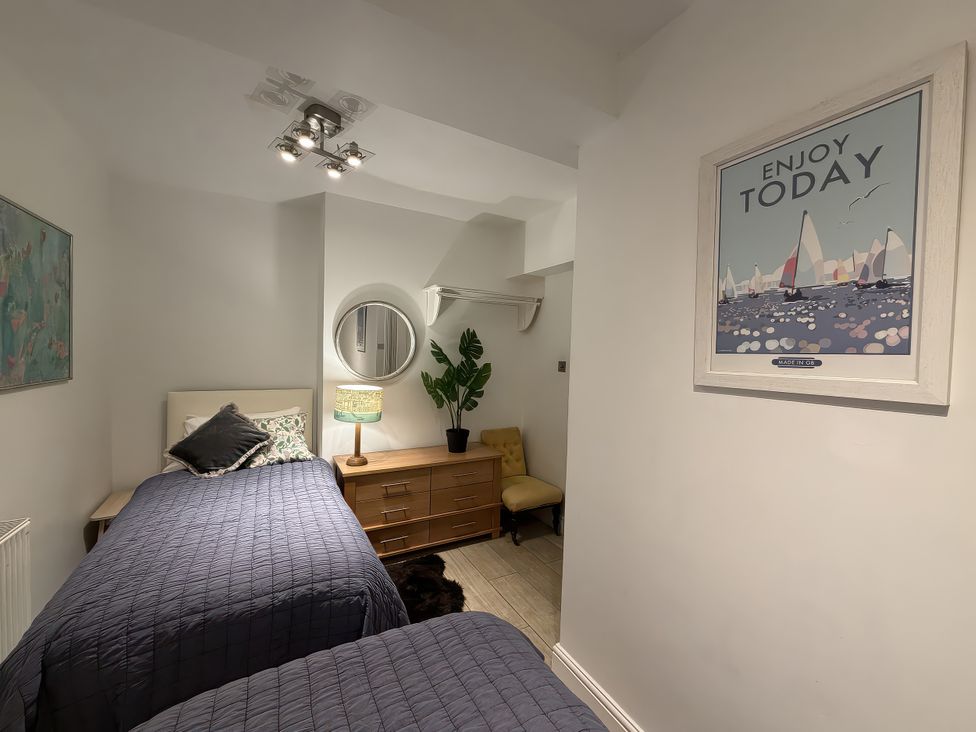 A bedroom with two beds and a dresser at Dart Views in Dartmouth