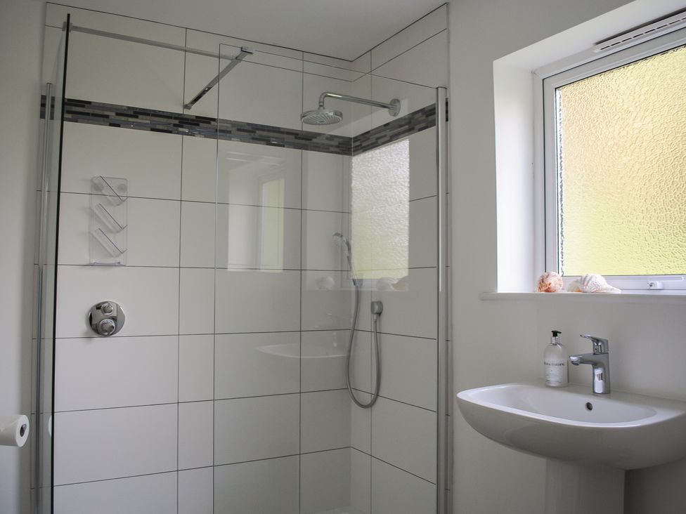 A bathroom with a shower and sink at Dolphins in Salcombe